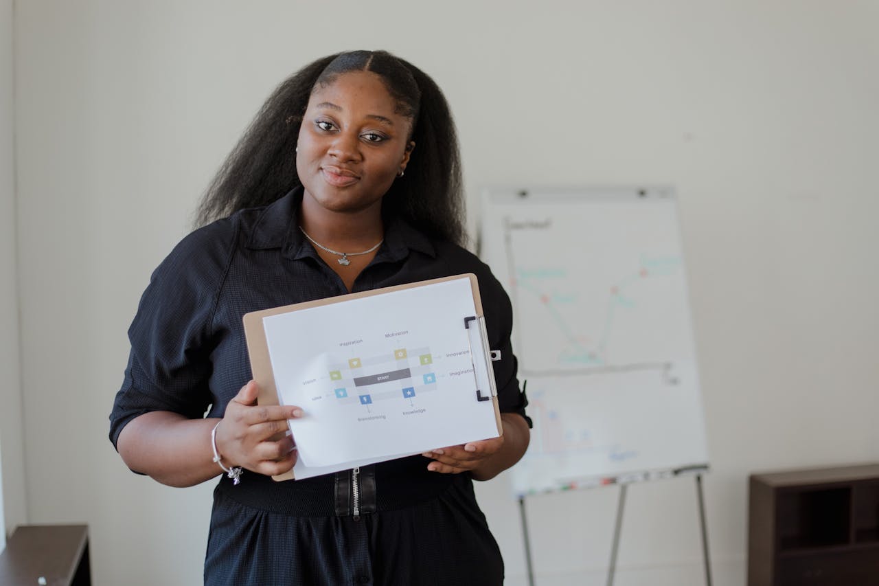 Woman in Blue Shirt Holding Brown Clipboard with White Paper